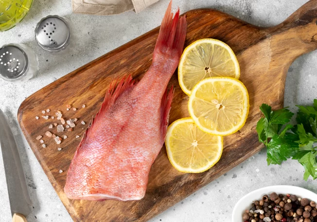 Redfish on a board with lemons